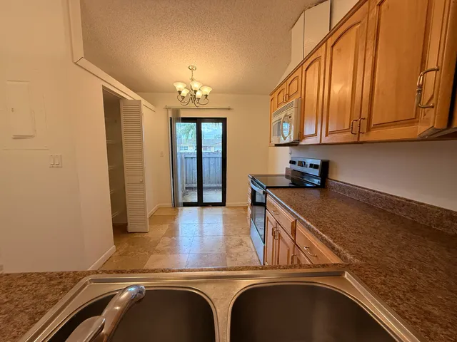 a kitchen with a refrigerator and a sink