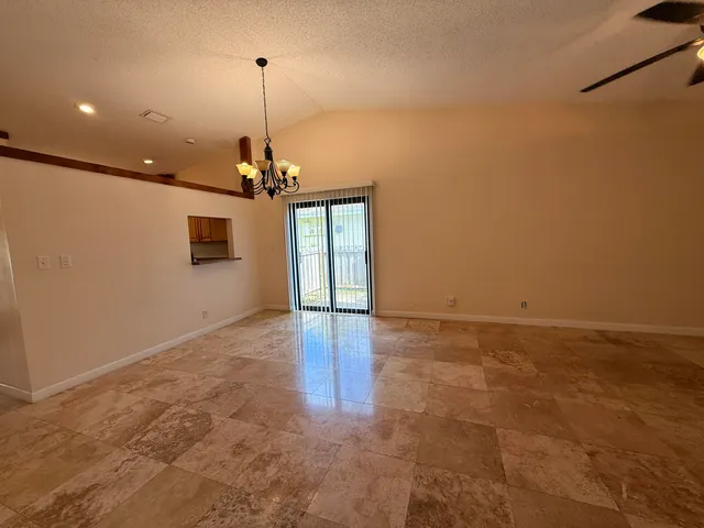 a view of a livingroom with a ceiling fan and window