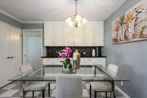 a view of a dining room with furniture and a chandelier