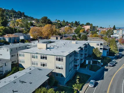 an aerial view of a house with garden space and street view