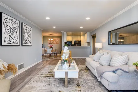 a living room with furniture and kitchen view