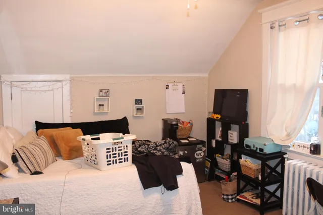 a bedroom with furniture and wooden floor