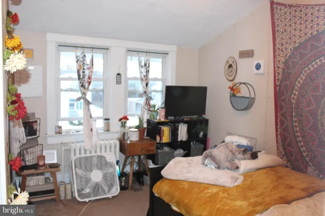 a bedroom with furniture and a window