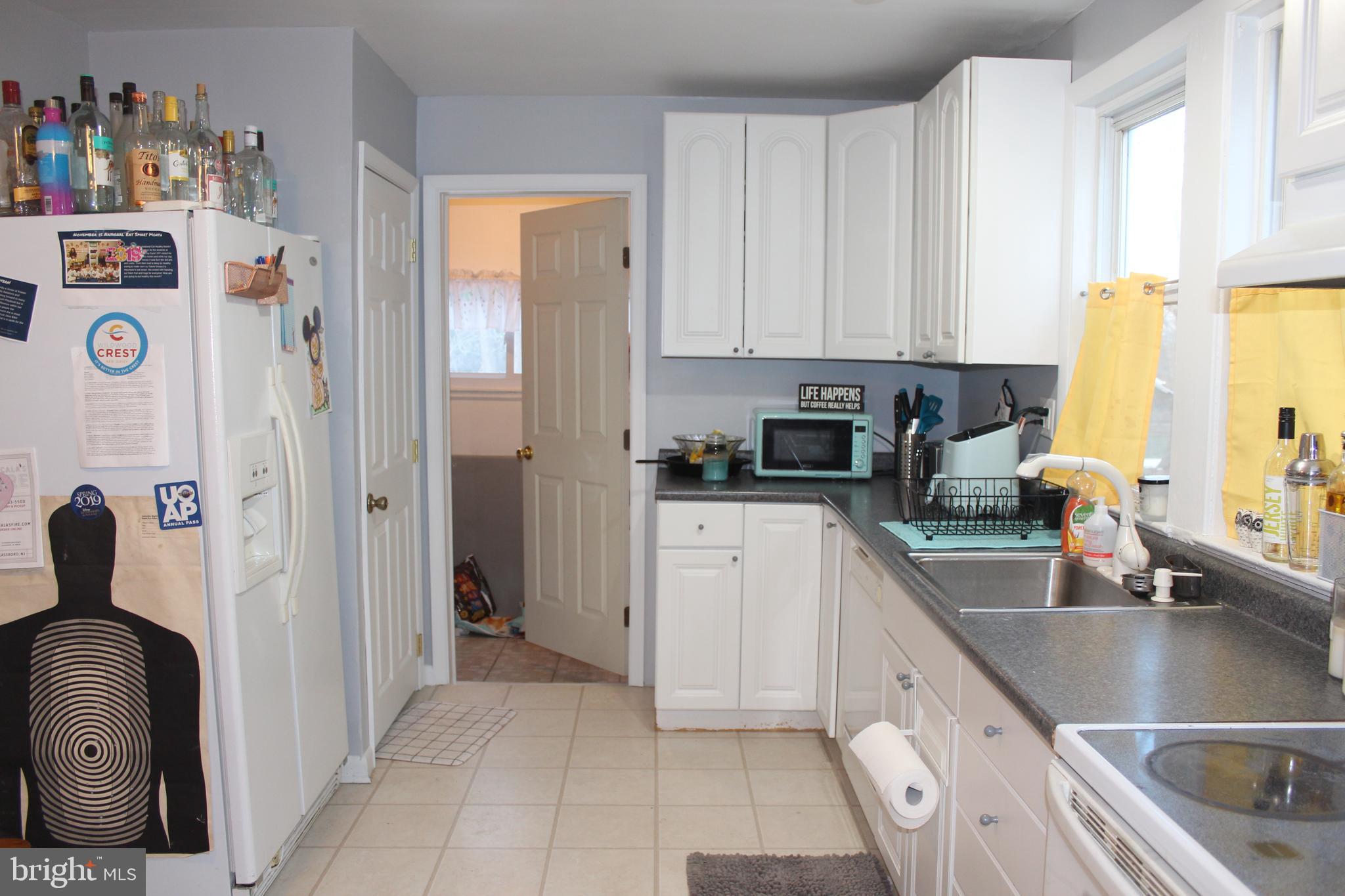 319 Swarthmore Road Glassboro, NJ 08028 - Photo 7 of 16 a kitchen with a sink a refrigerator and cabinets
