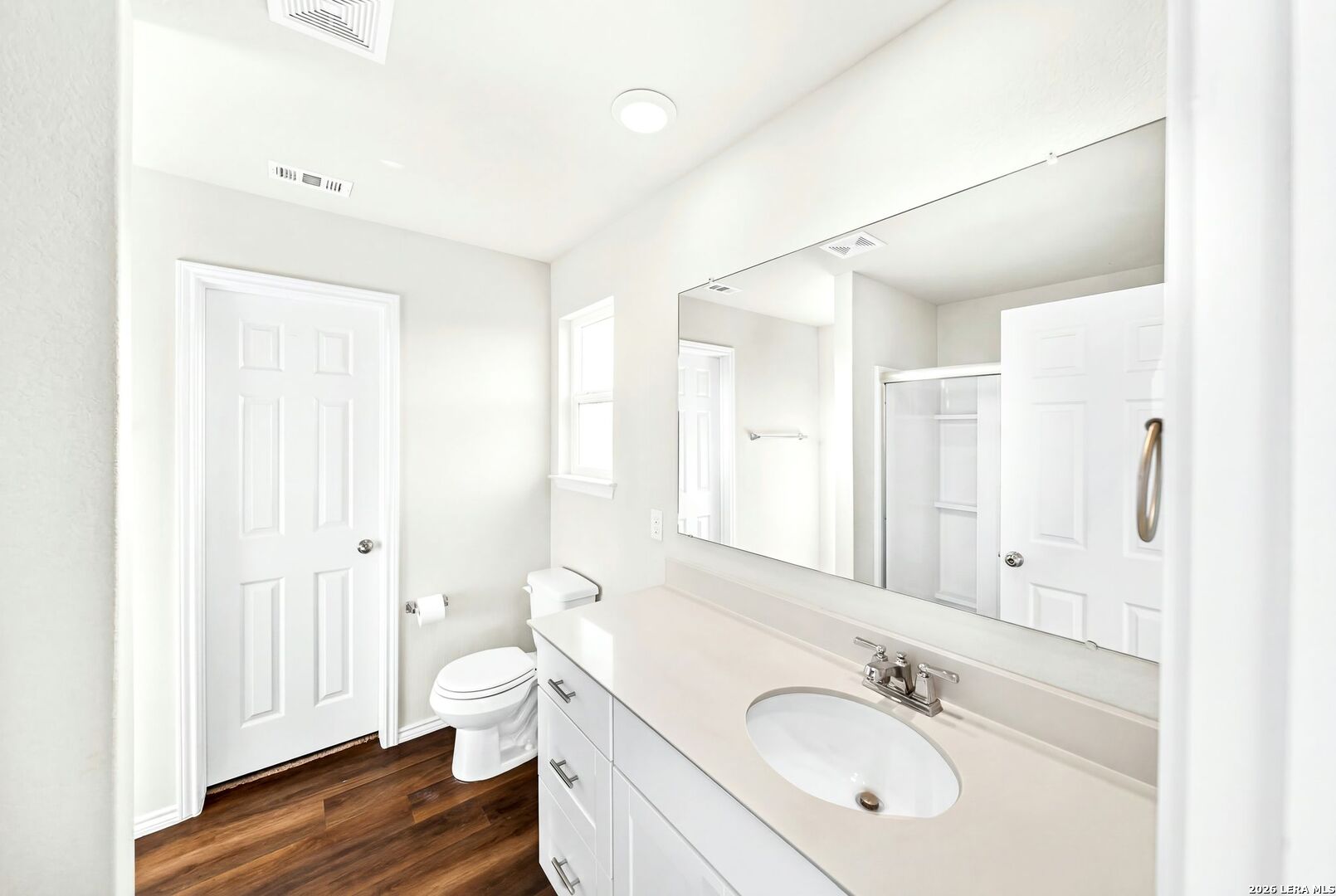 6710 Turnpike Converse, TX 78109 - Photo 15 of 34 a bathroom with a sink a toilet and a large mirror