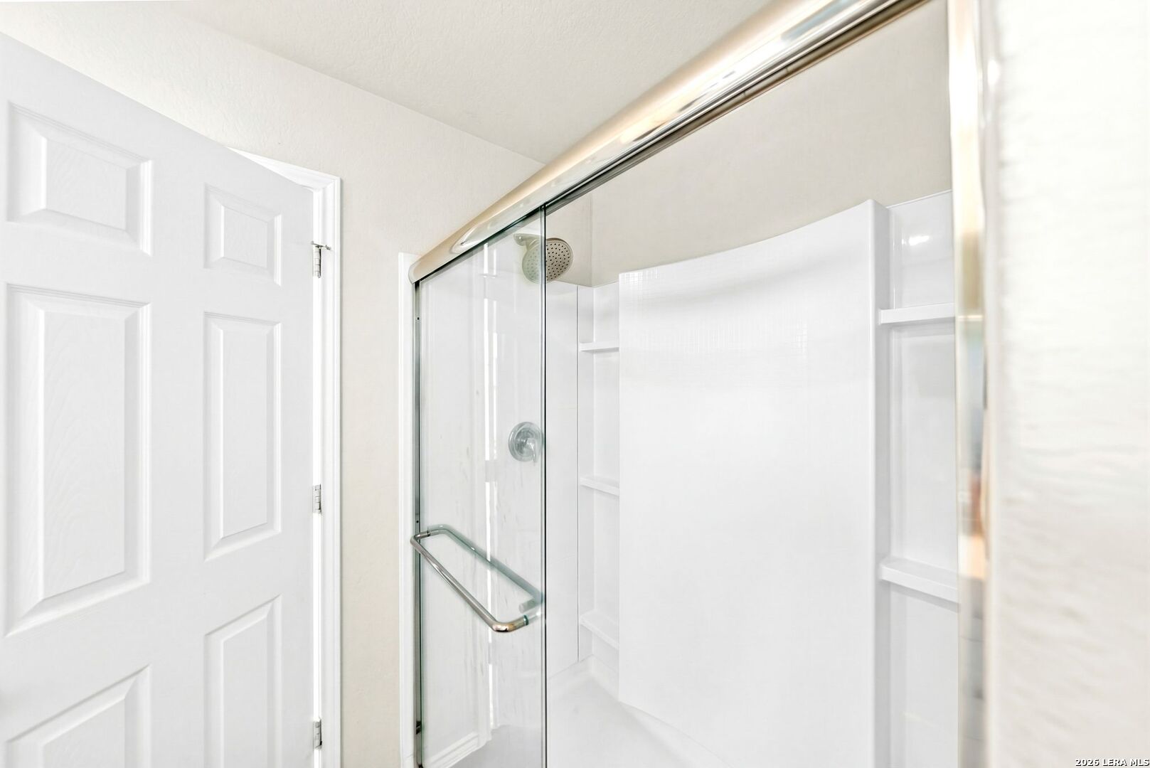6710 Turnpike Converse, TX 78109 - Photo 16 of 34 a bathroom with a glass shower door
