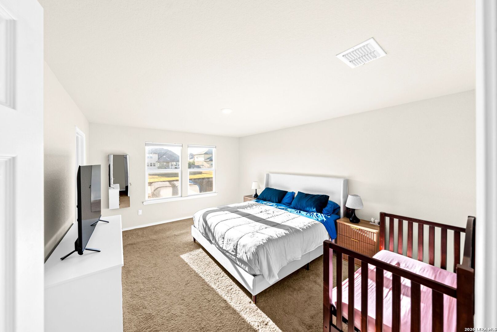 6710 Turnpike Converse, TX 78109 - Photo 32 of 34 a bedroom with a bed a window and dresser