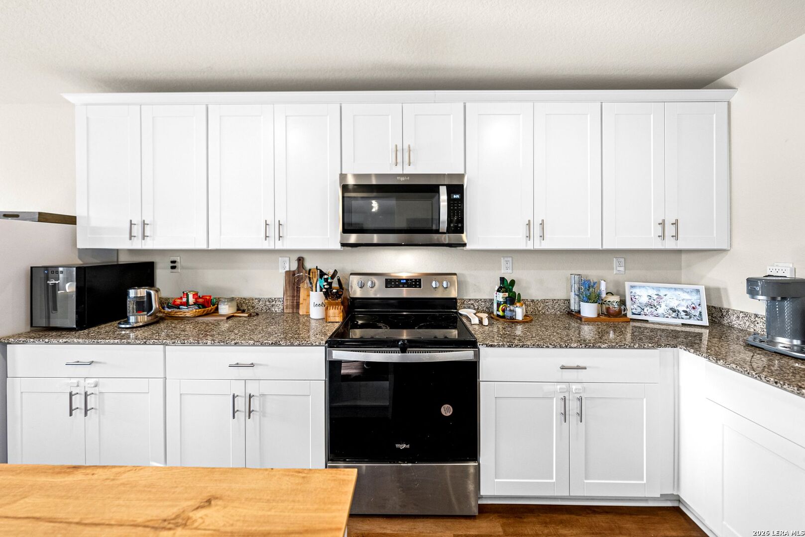 6710 Turnpike Converse, TX 78109 - Photo 10 of 34 a kitchen with white cabinets and black appliances