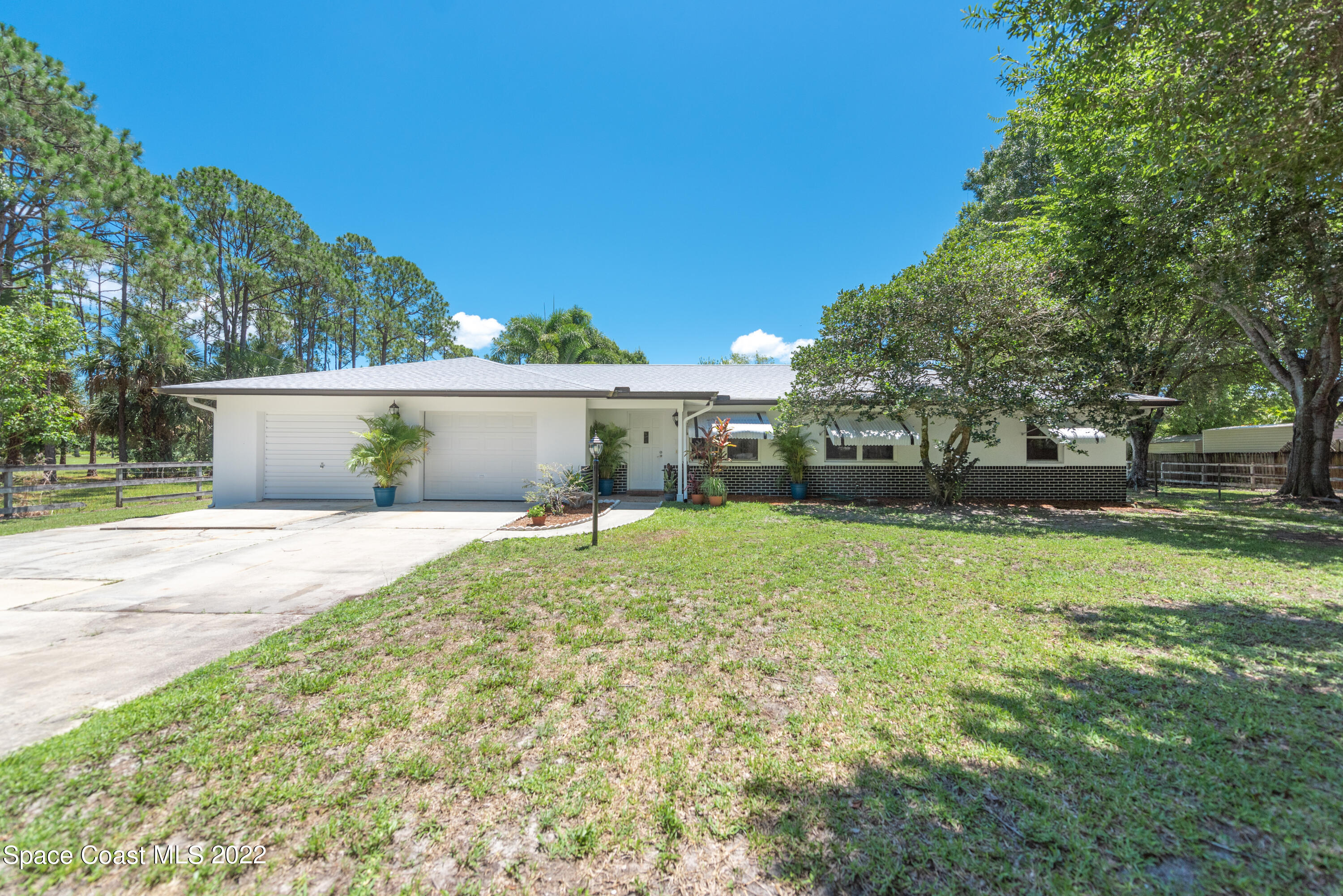 a view of a house with a yard and a garden