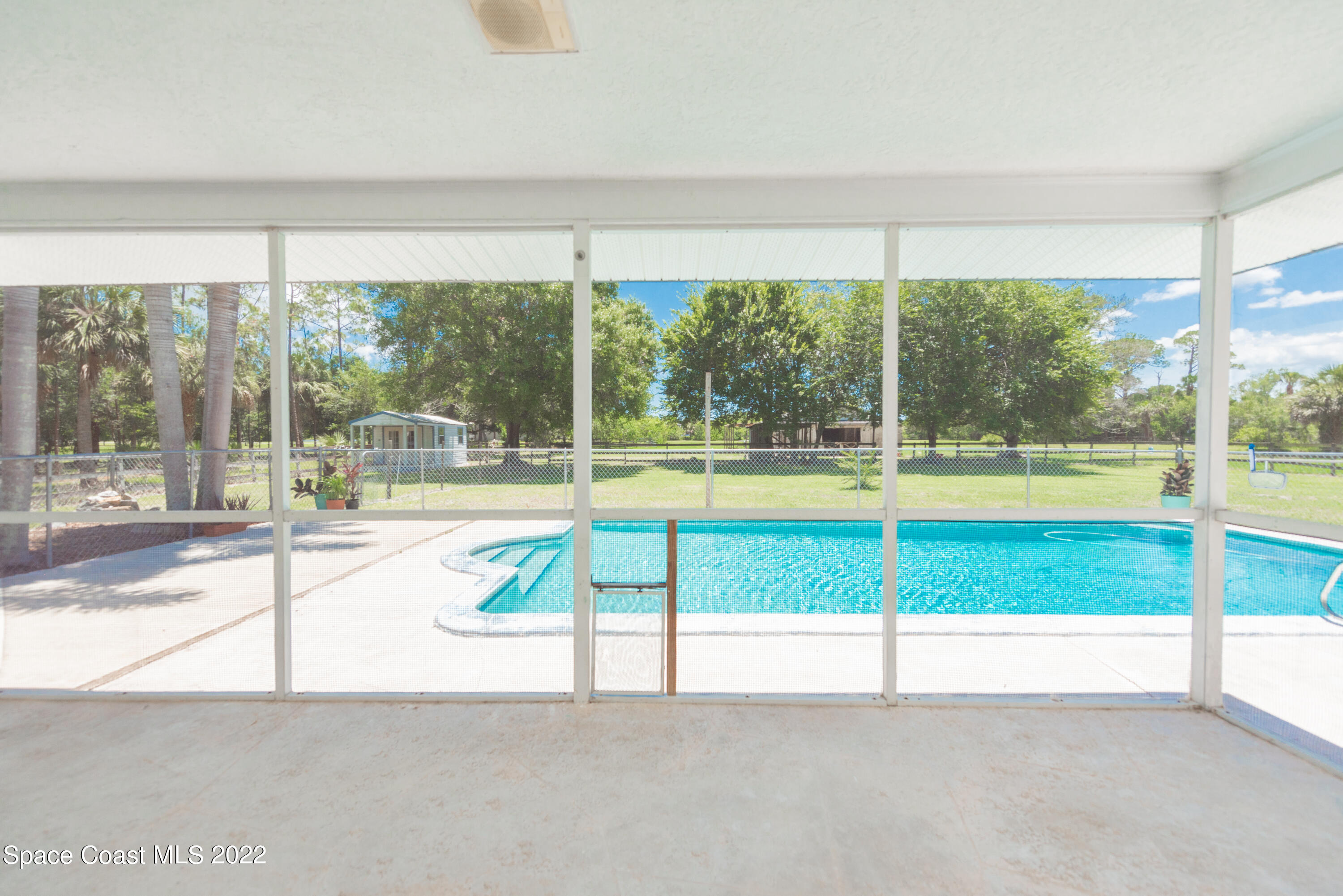 2085 Harlock Road Melbourne, FL 32934 - Photo 14 of 27 a view of an empty room with a floor to ceiling window and an outdoor view