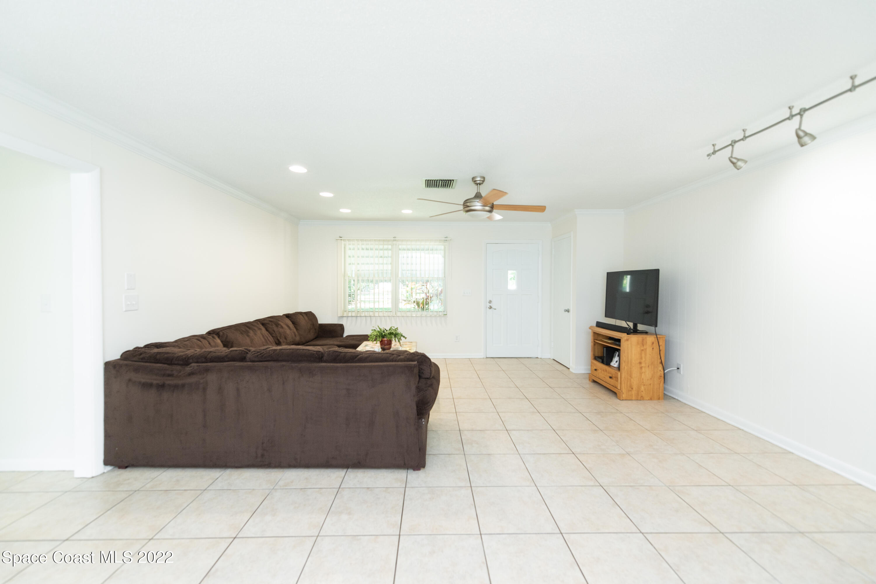 2085 Harlock Road Melbourne, FL 32934 - Photo 3 of 27 a room with a bed and a television