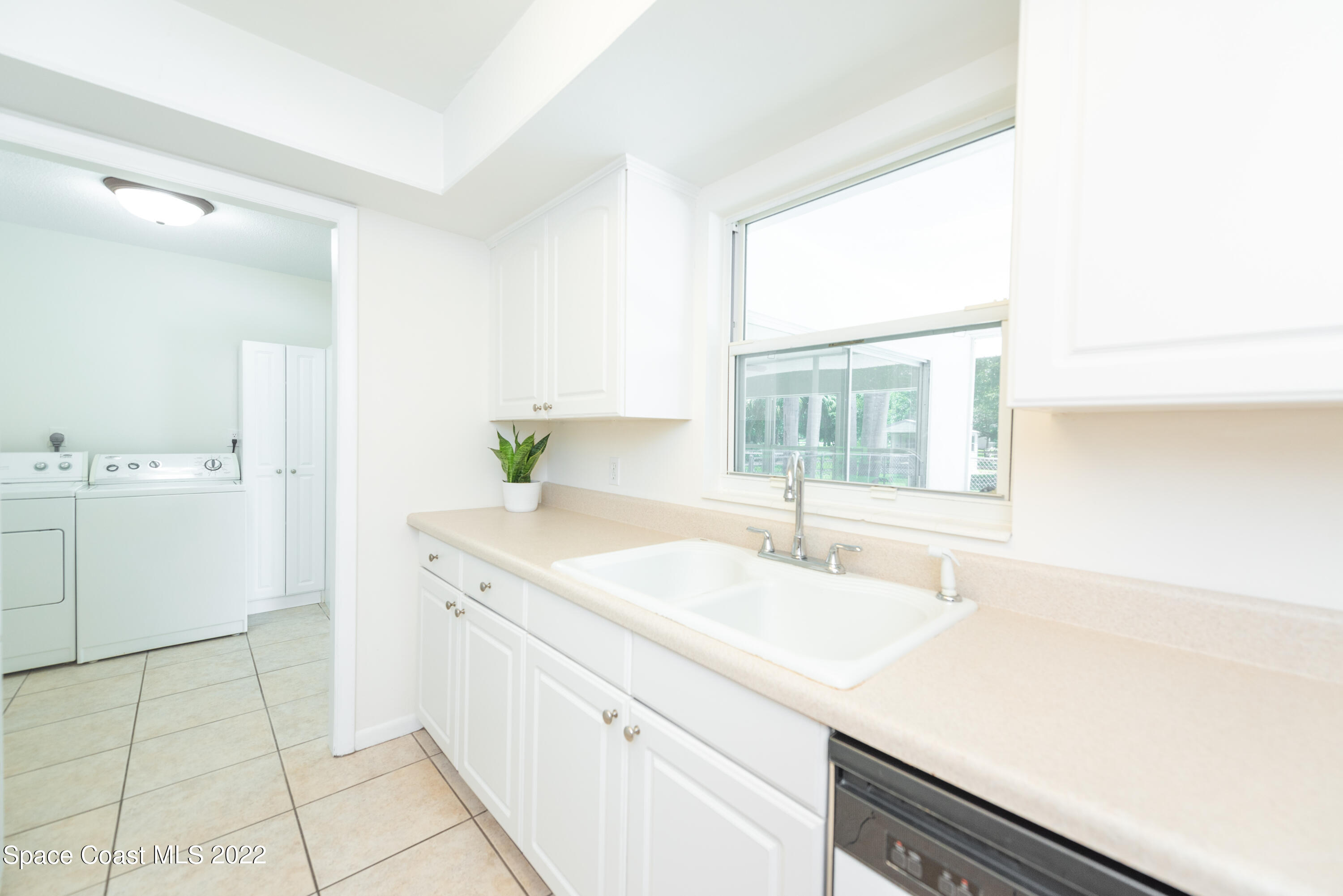 2085 Harlock Road Melbourne, FL 32934 - Photo 5 of 27 a kitchen with a sink cabinets and window