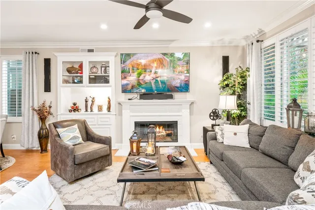 a living room with furniture a fireplace and a flat screen tv
