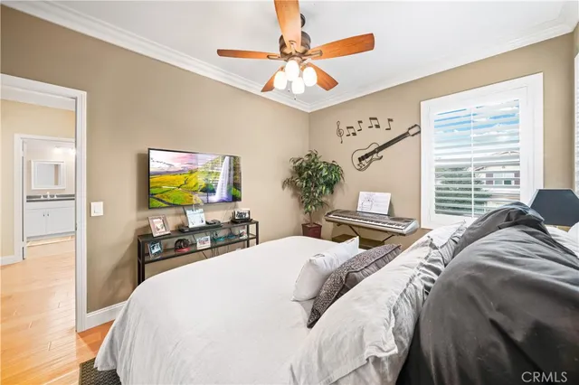 a bedroom with bed and a flat tv screen on dresser