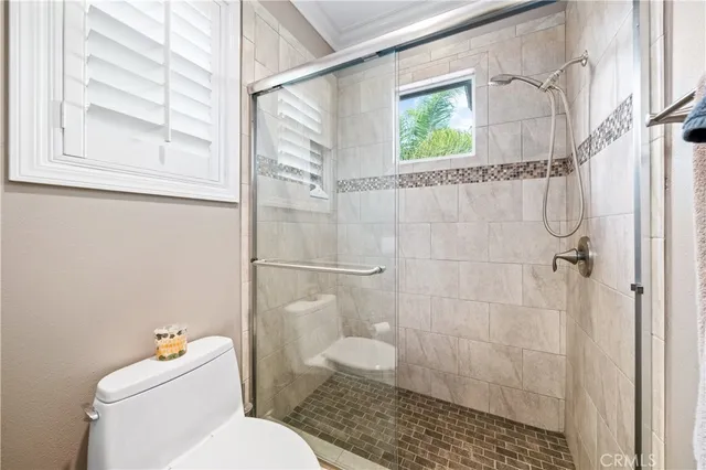 a white toilet sitting next to a bathroom sink