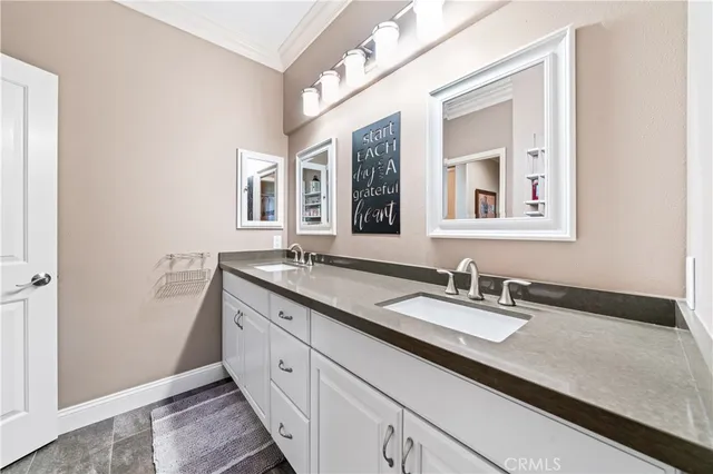 a spacious bathroom with a double vanity sink and a mirror