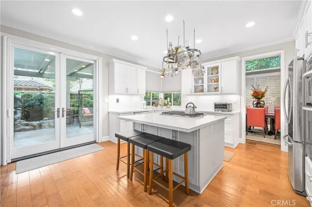 a large white kitchen with a large window