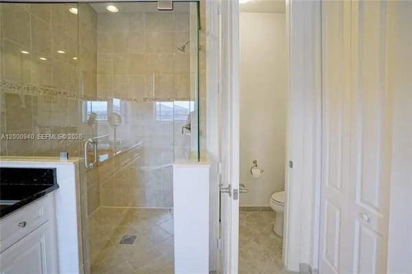 an empty room with windows and wooden floor