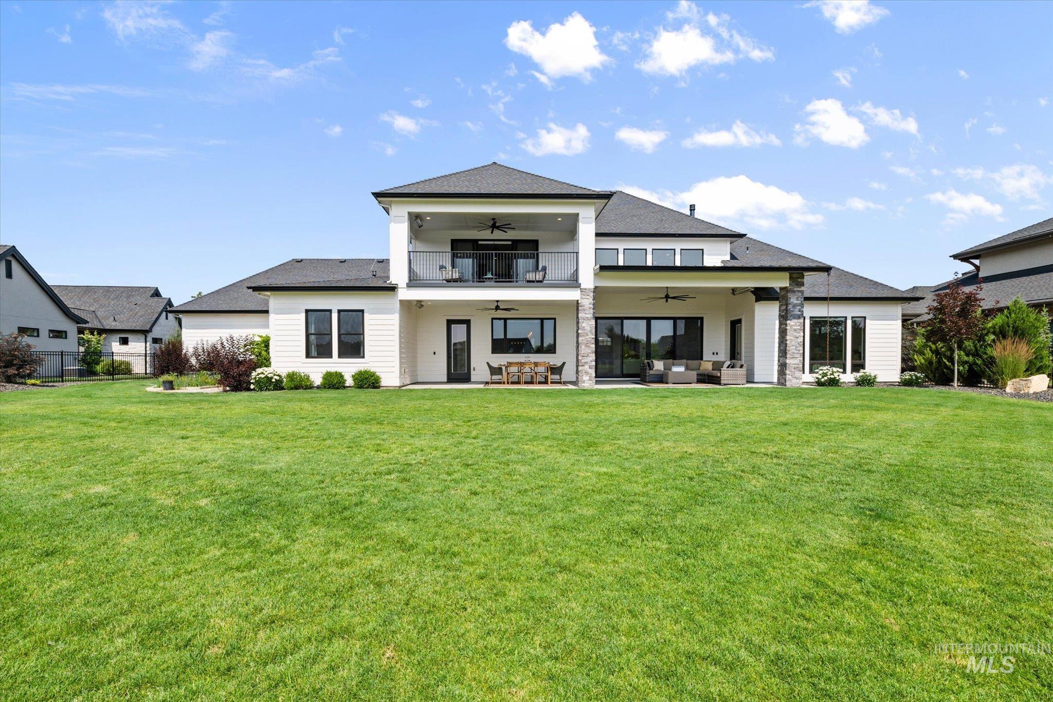 2248 South Trout Stone Way Eagle, ID 83616 - Photo 33 of 50 Back of property with ceiling fan, an outdoor hangout area, a lawn, and a patio