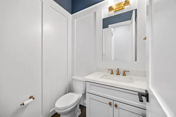 a bathroom with a sink a toilet and a mirror