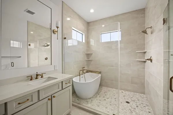 a bathroom with a granite countertop sink toilet a shower and a mirror