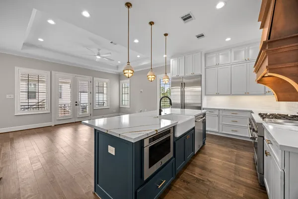 a kitchen with stainless steel appliances granite countertop a stove and a wooden floors