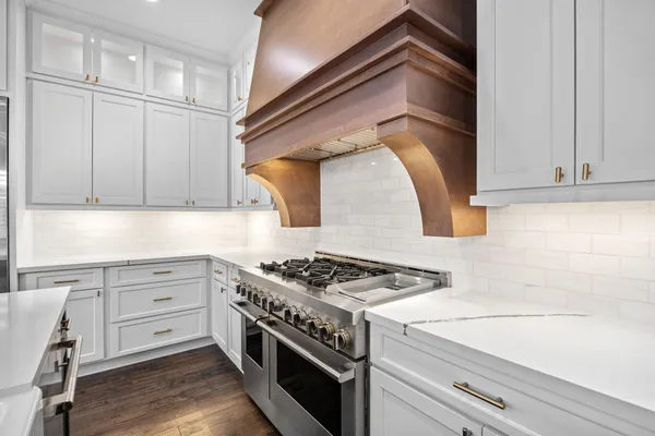 a kitchen with granite countertop white cabinets and white appliances