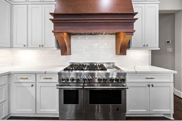 a stove top oven sitting inside of a kitchen