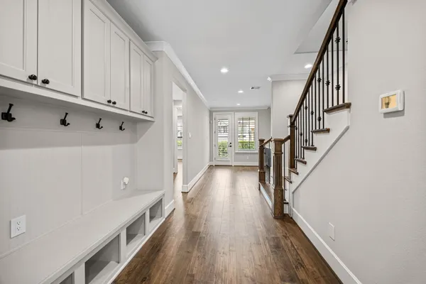 a view of a kitchen with wooden floor and stairs