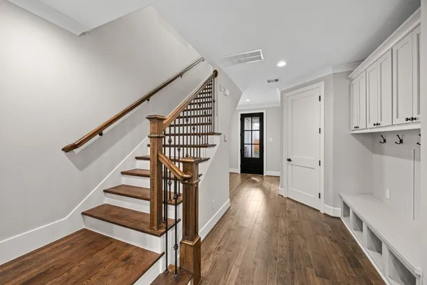 a view of entryway with wooden floor and stairs