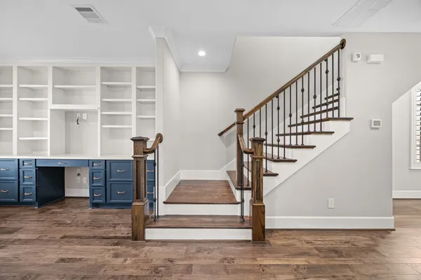 a view of entryway and hall with wooden floor