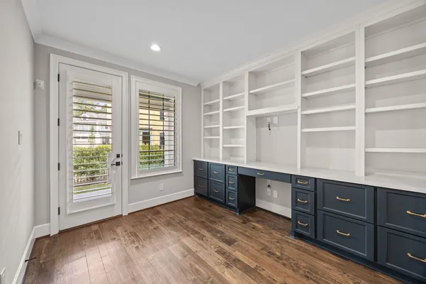 a room with a dresser and a window