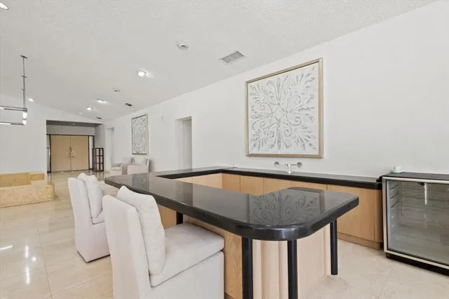 a kitchen with granite countertop a sink and a counter top space