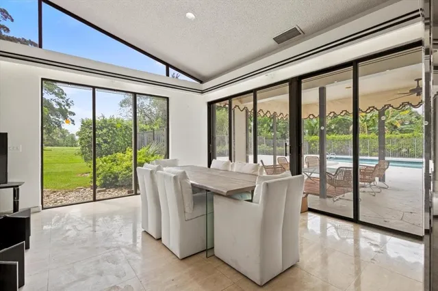 a living room with furniture and large windows
