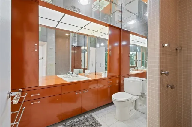 a bathroom with a tub sink and mirror
