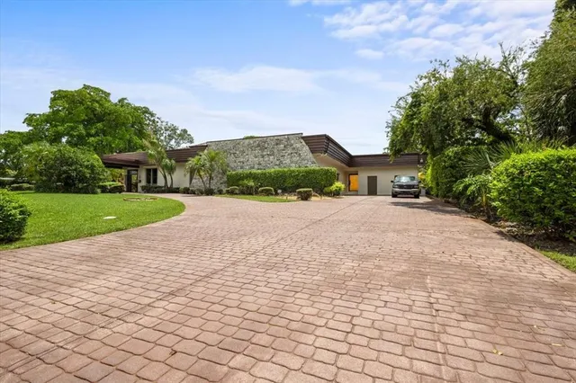 a pathway of a house with a yard