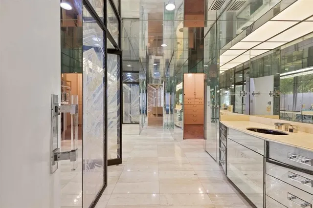 a bedroom with a large bed and a large mirror