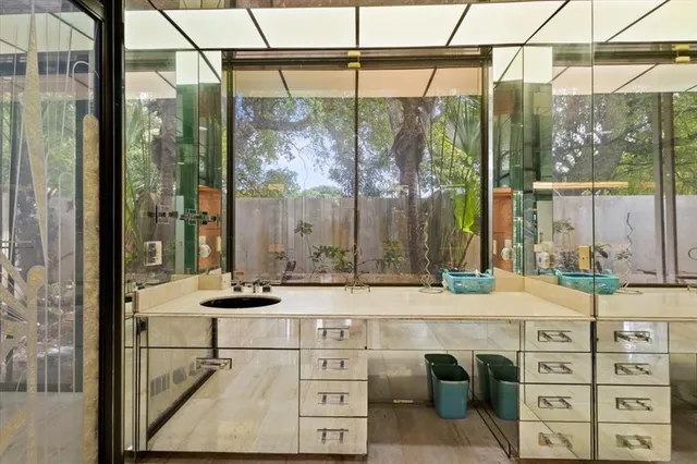 a view of a workspace with furniture and a window