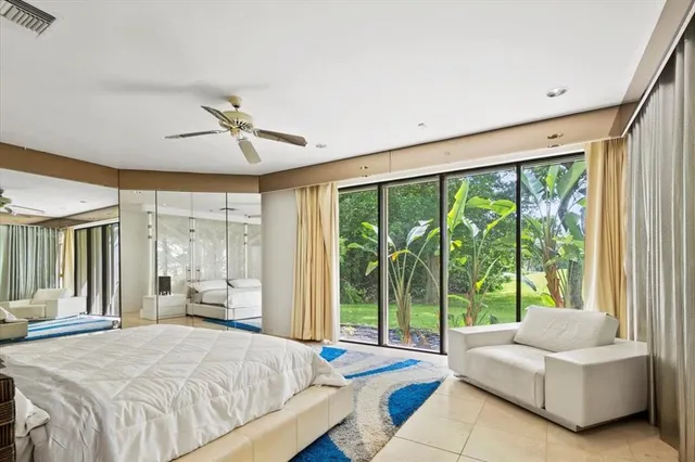 a bedroom with a large bed and a large window