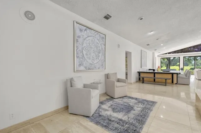 a dining room with furniture and a large window