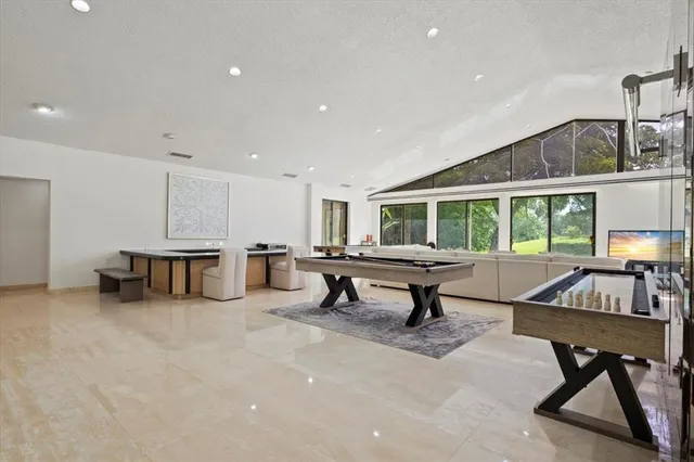 a living room with furniture a table and a painting