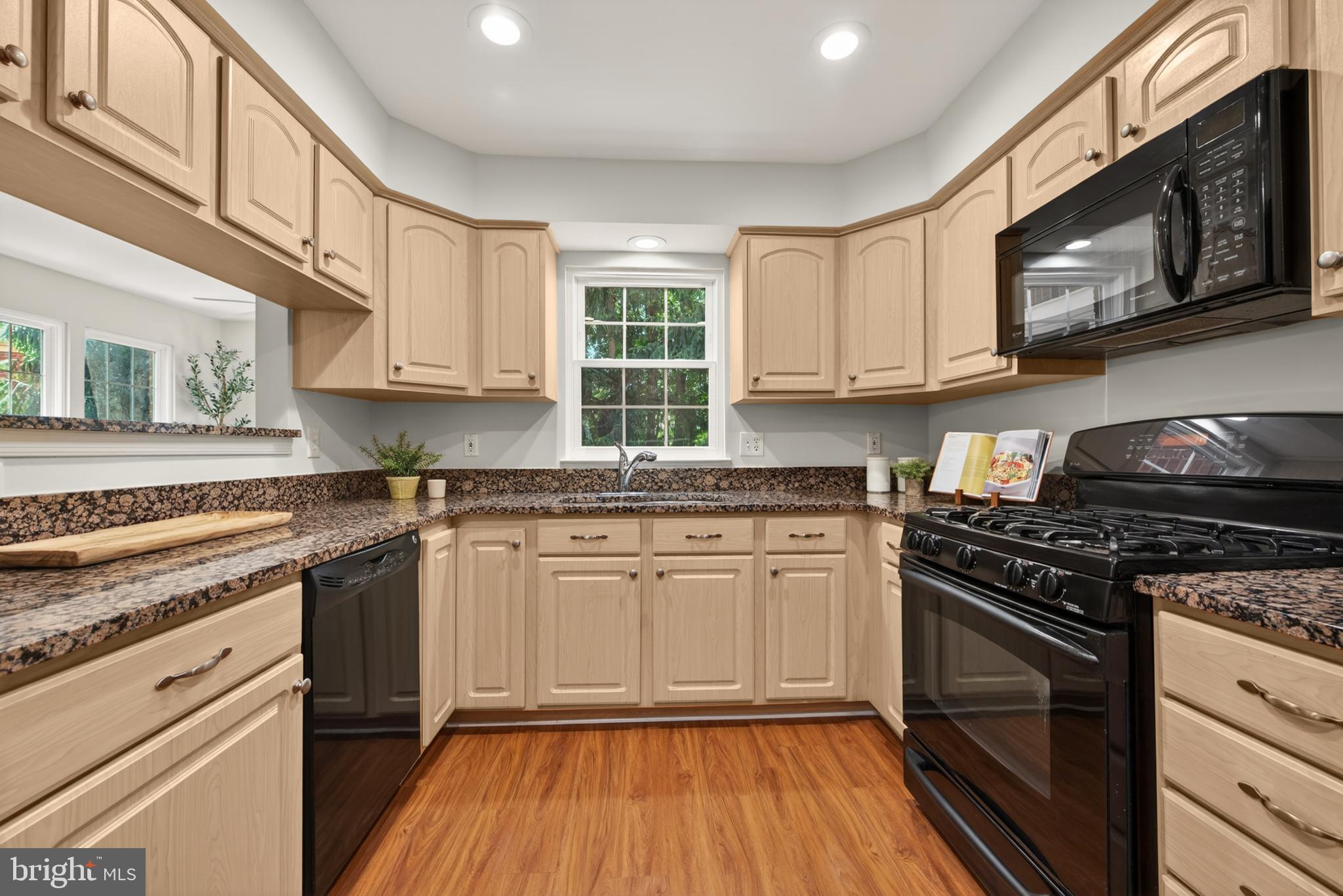 1409 Park Garden Lane Reston, VA 20194 - Photo 17 of 41 a kitchen with stainless steel appliances granite countertop a stove a sink and a microwave