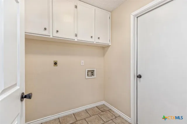 a view of wooden floor and a chandelier fan in a room