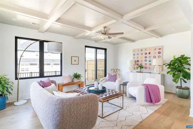 a living room with furniture and flowers