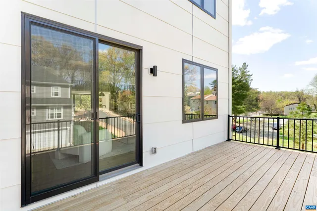a view of a balcony with wooden floor