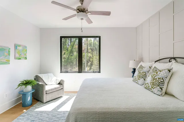 a bedroom with a bed couch and window