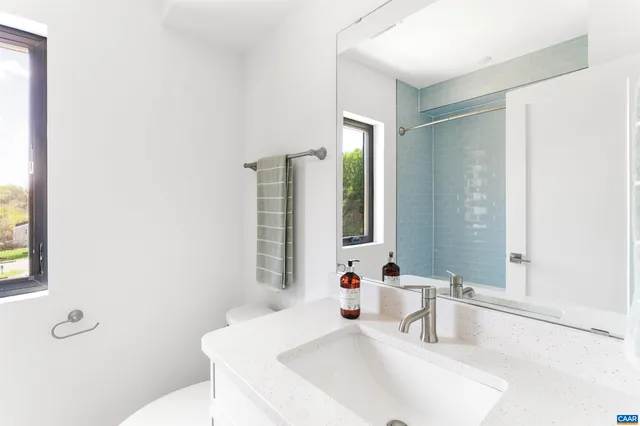 a bathroom with a sink and a large mirror