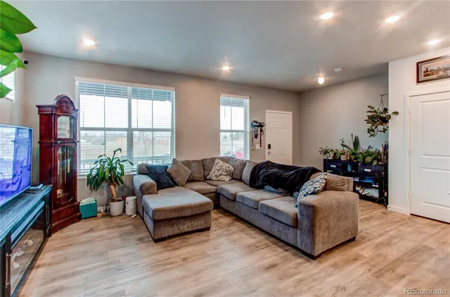 a living room with furniture window and flat screen tv