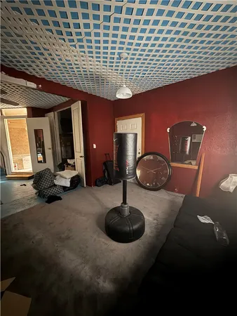 a room with pool table and windows