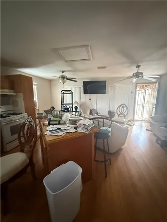 a living room with furniture a large window and potted plants